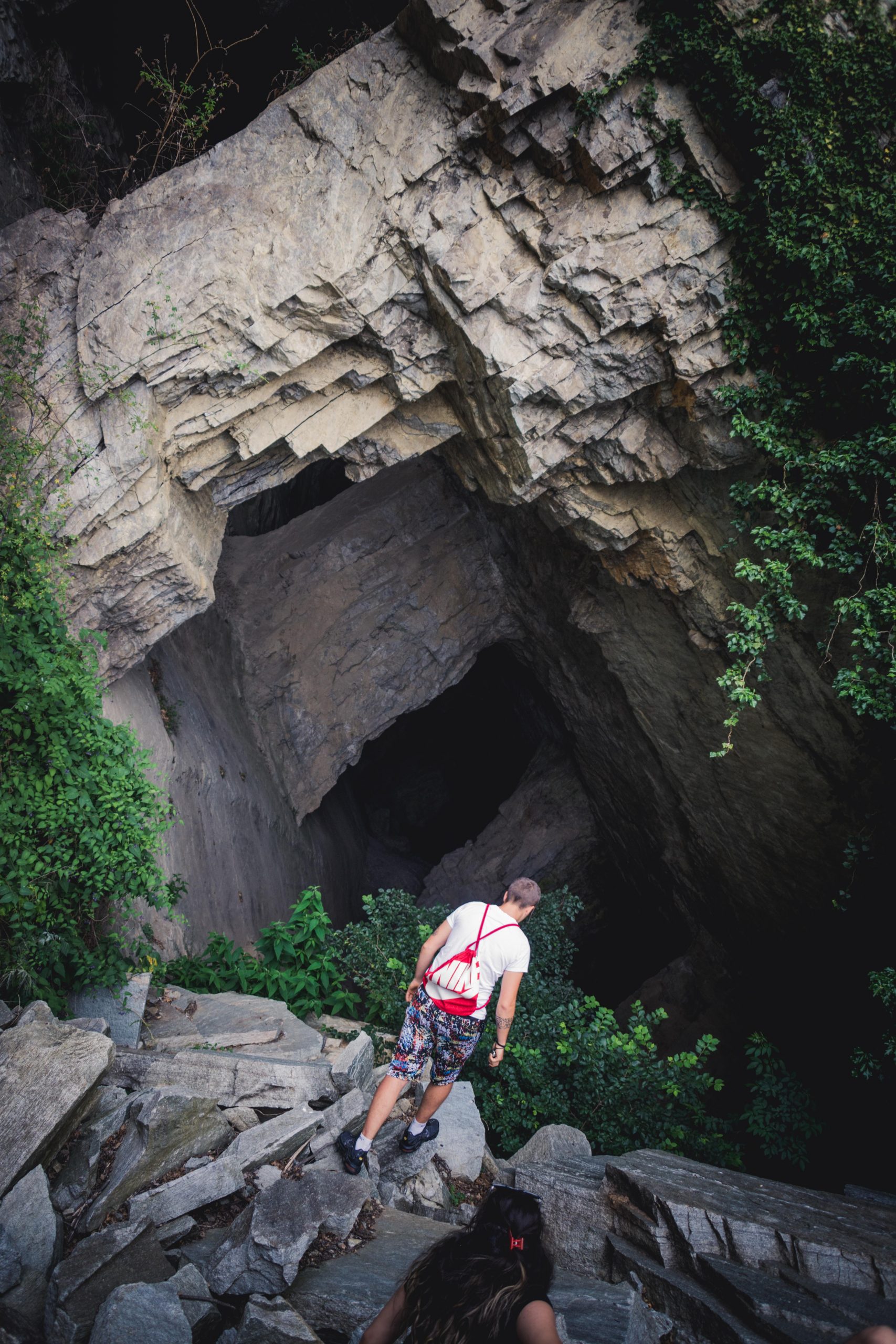 The entrance of a big cave made of naturally formed pillars of stone