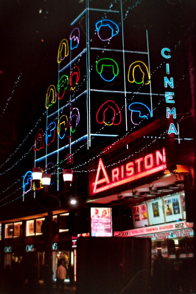 A Night time photo of the "Ariston Theathre" in San Remo, decorated with christmas lights