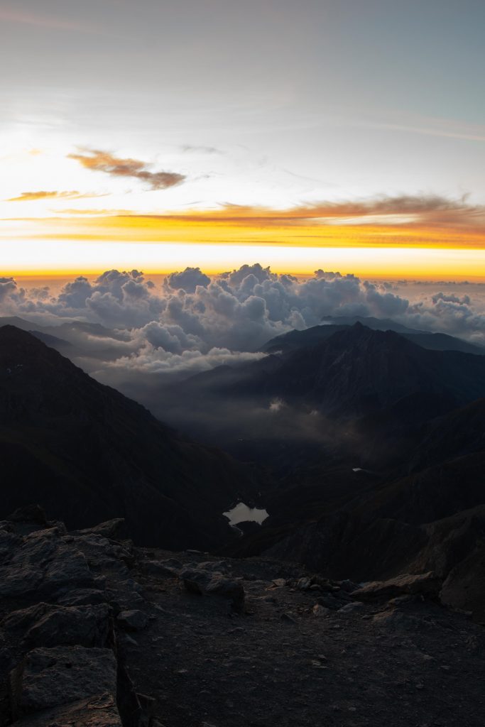 Photo of a lake at sunrise, seen from the top of a mountain