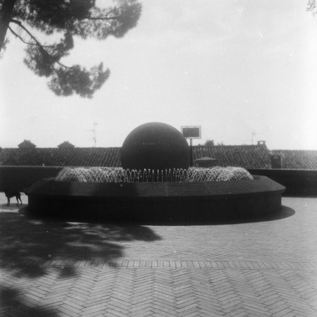 City fountain with a big concrete ball in the middle