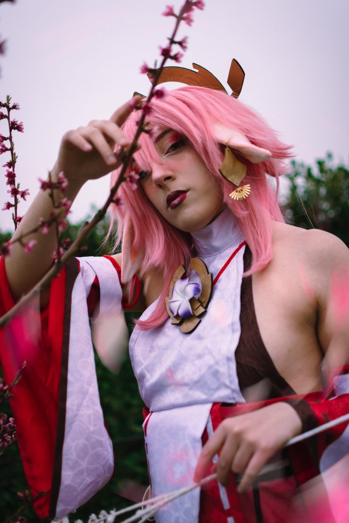 A Girl in a Yae Miko Cosplay near some cherry blossoms