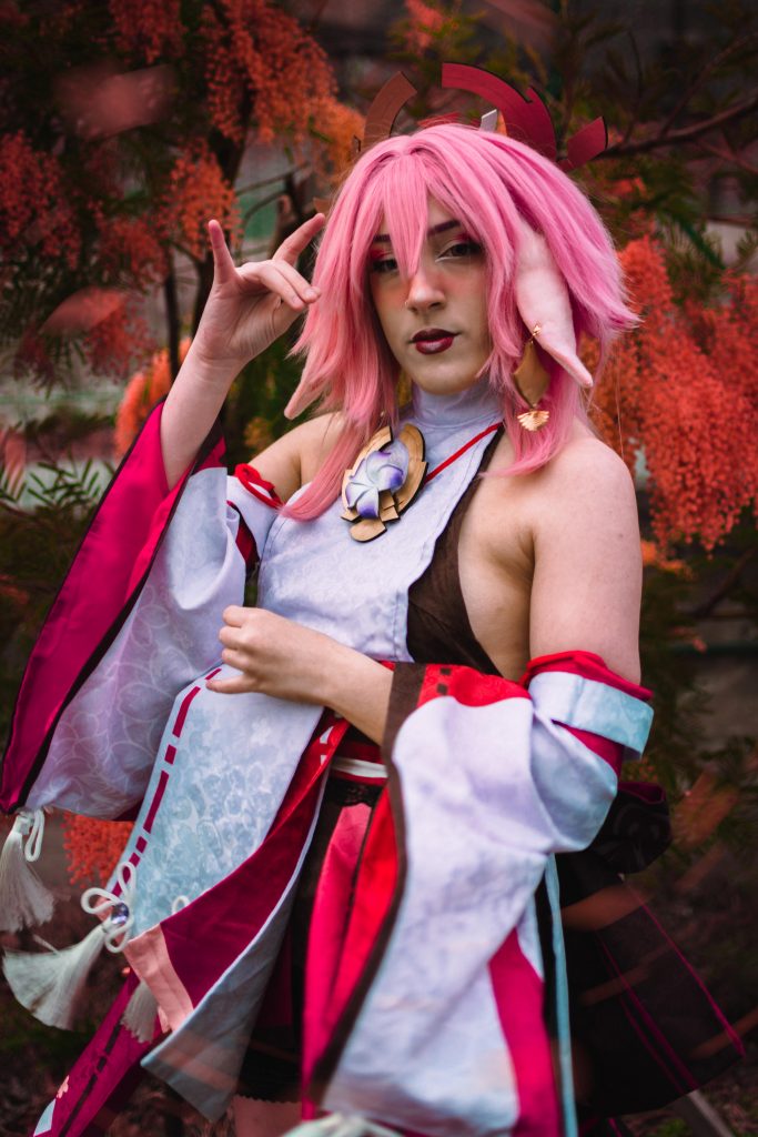 A girl in a Yae Miko Cosplay posing as the character